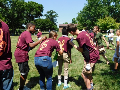 Students signing each other's shirts at camp