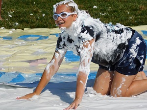 Student on Slide Covered with Shaving Cream